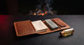 Leather knife care kit laid out flat with a bench stone, a strop insert, a cloth and a bottle of oil