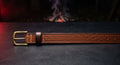 Hand tooled leather belt with a basket weave face, stitched keeper and a solid brass buckle
