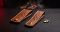 A pair of hand stitched leather dangler belt loops with basket weave faces and solid brass press studs