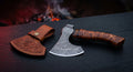 Damascus carving axe with a bearded head, burl wood and resin handle and a hand carved leather cover
