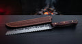 Hand forged bread knife with a deep scalloped serrated edge and a rosewood handle