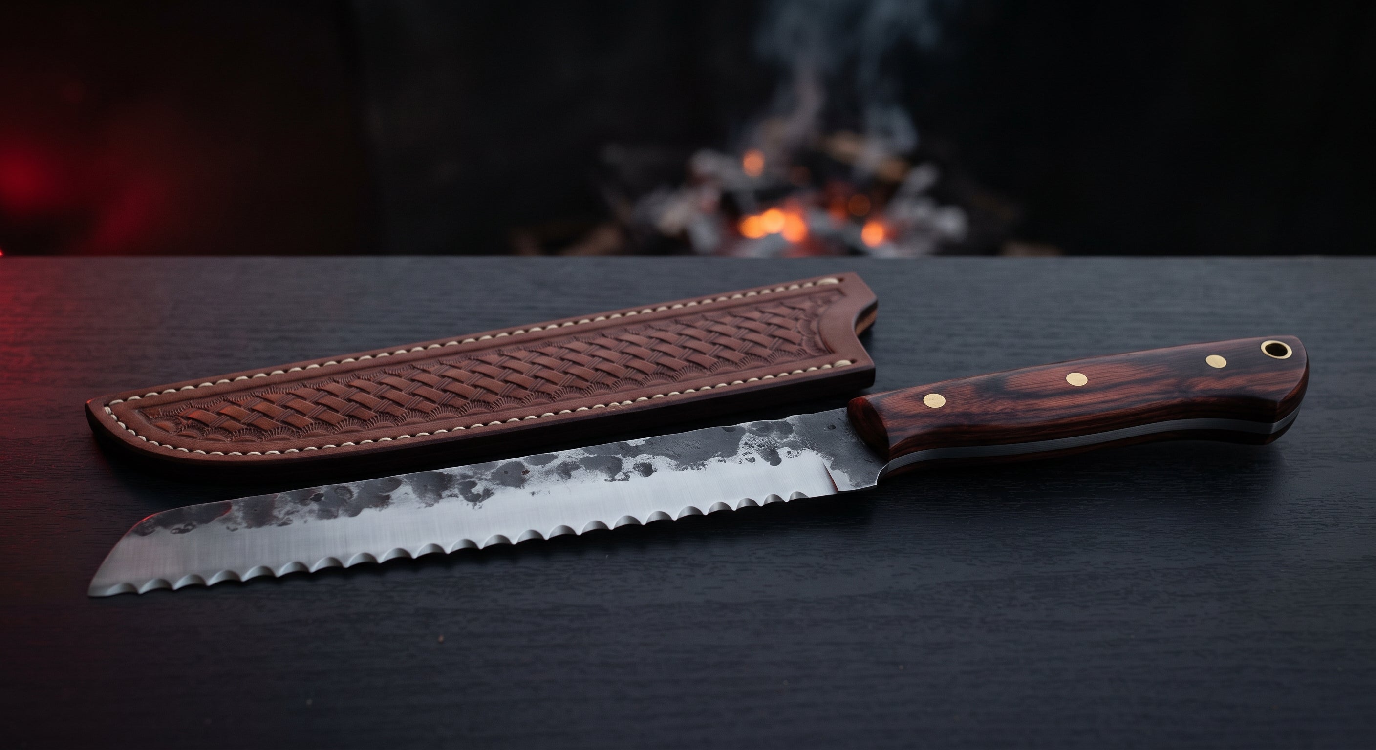 Hand forged bread knife with a deep scalloped serrated edge and a rosewood handle
