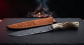 Damascus carving knife with a long narrow twist pattern blade and a stag antler handle