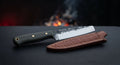 Hand forged kitchen utility knife with a tall straight sided blade and a green canvas micarta handle