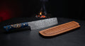 Damascus nakiri knife with a tall straight edged raindrop pattern blade and a burl wood and blue resin handle