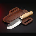 rasp steel bull cutter knife with white bone handle and tooled pancake sheath