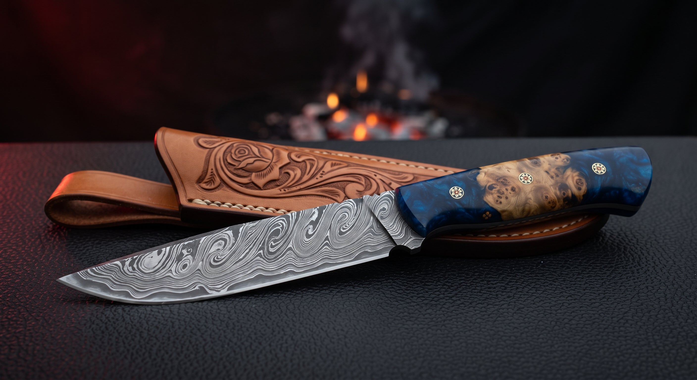 One of a kind Damascus hunting knife with a twist pattern blade and a stabilised burl and blue resin handle with mosaic pins