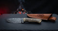 One of a kind Damascus skinner knife with a twist pattern blade and a scrimshawed camel bone handle