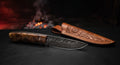 One of a kind Damascus hunting knife with a ladder pattern blade, desert ironwood burl handle and filework along the spine