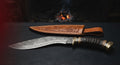 One of a kind Damascus kukri with a twist pattern blade, ram horn handle and a brass butt cap
