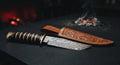 One of a kind Damascus bowie knife with a twist pattern blade and a stacked leather handle with brass guard and pommel
