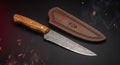Damascus boning knife with olive wood handle and stamped leather sheath