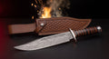 Damascus bowie knife with stacked leather handle, steel guard and tooled leather belt sheath