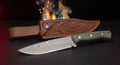 Damascus camp knife with green micarta handle and tooled leather belt sheath