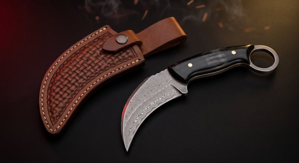 Damascus karambit knife with black buffalo horn handle, finger ring and tooled leather sheath