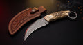 Damascus karambit knife with stag antler handle, finger ring and hand carved leather sheath