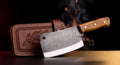 Damascus meat cleaver with olive wood handle and tooled leather blade cover