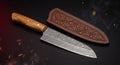 Damascus santoku knife with olive wood handle and stamped leather sheath