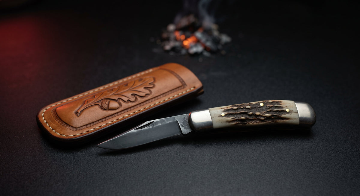 Closed hand forged trapper pocket knife with a stag antler handle and nickel silver bolsters