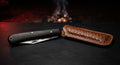 Closed hand forged sodbuster folding knife with a plain black ebony handle and no bolsters