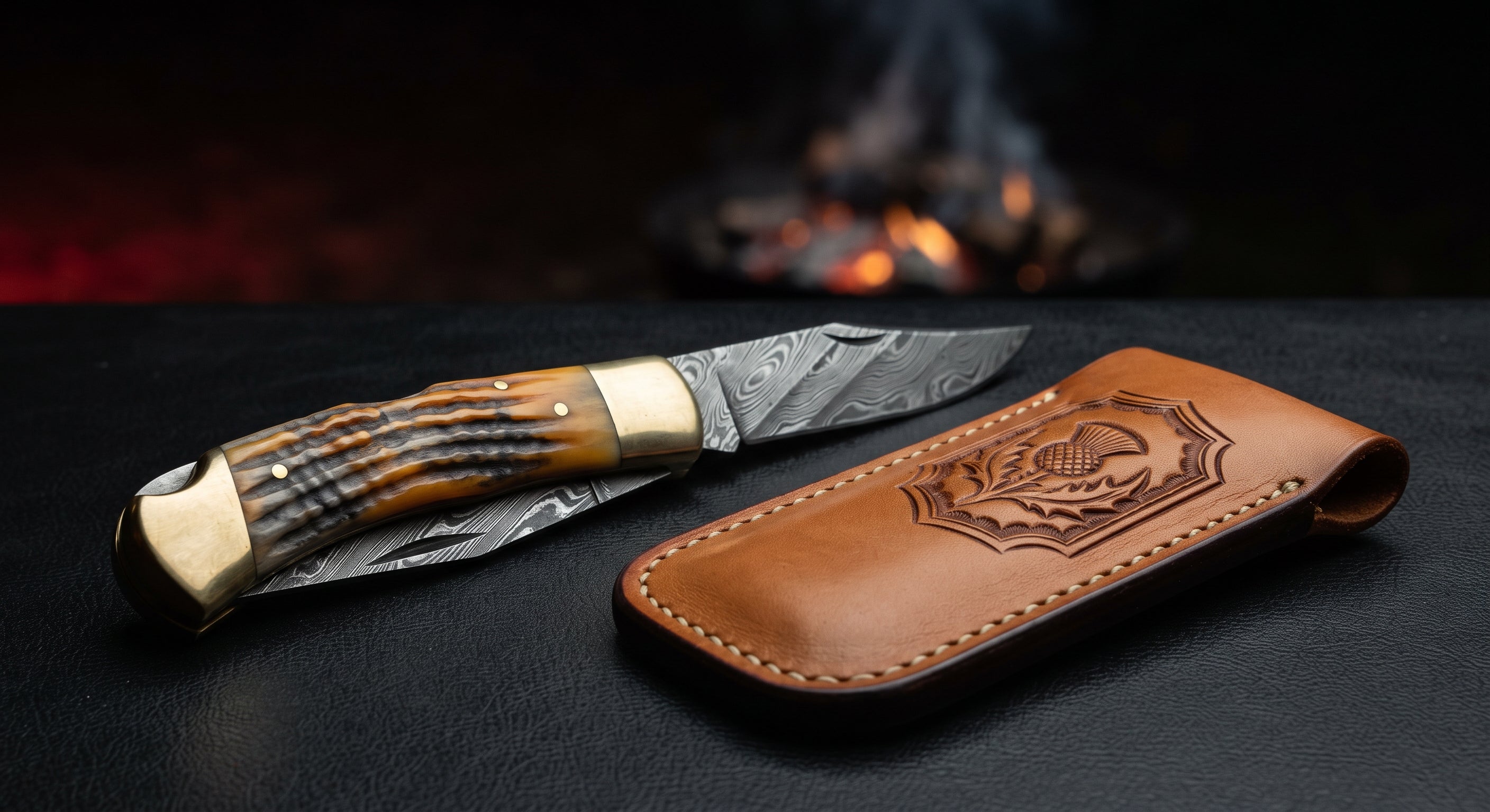 Closed Damascus folding knife with a ridged ram horn handle and brass bolsters