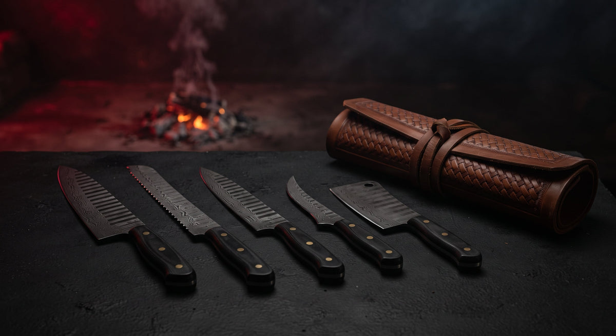 Damascus BBQ knife set of five with black handles beside a closed tooled leather knife roll