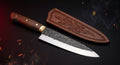 Hand forged carbon steel chef knife with rosewood handle and stamped leather sheath