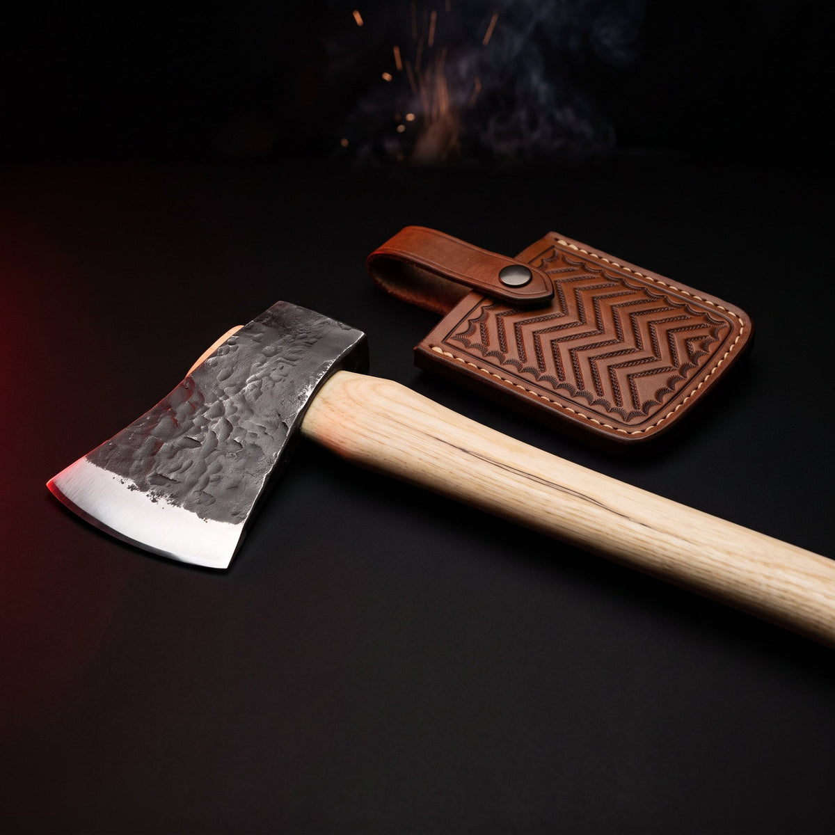 Hand forged carbon steel throwing axe with hickory handle and tooled leather head cover