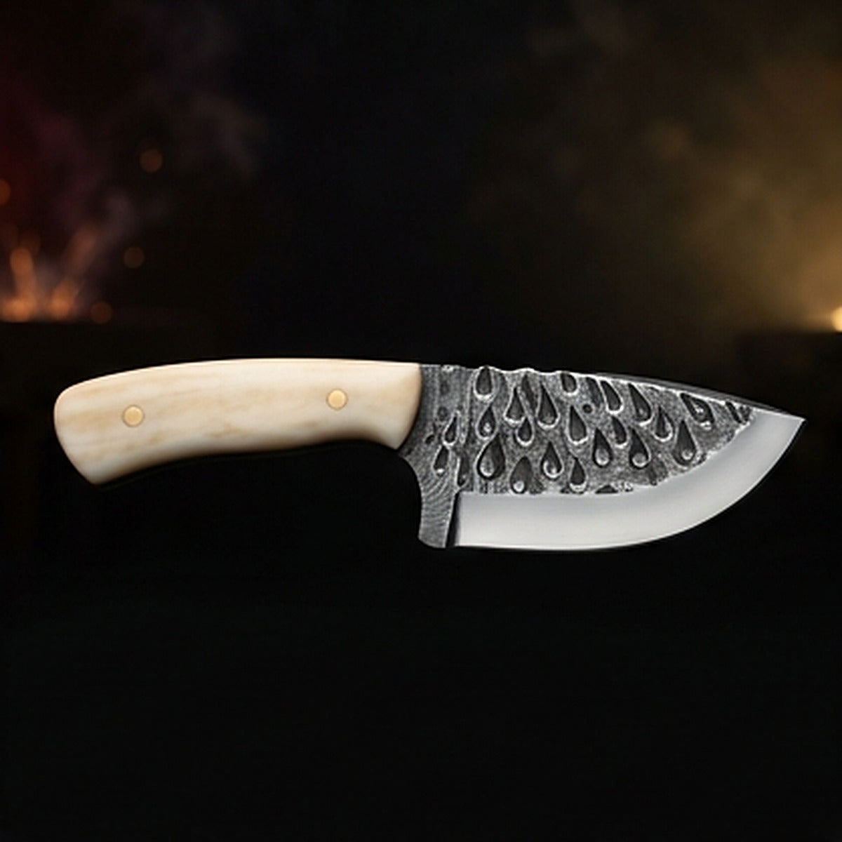 Damascus steel skinning knife with polished camel bone handle and brass pins, right side profile