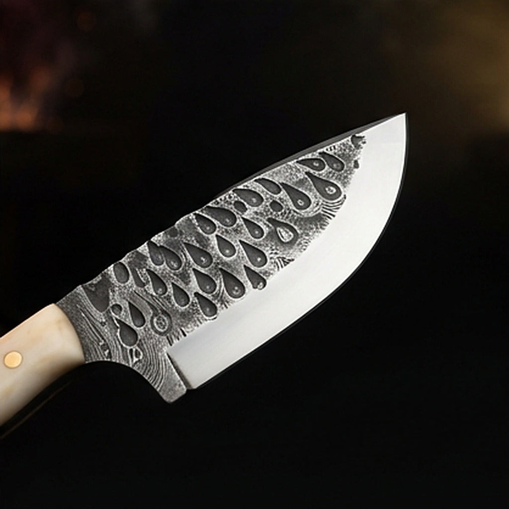 Damascus steel skinning knife with polished camel bone handle and brass pins, cutting edge and tip detail