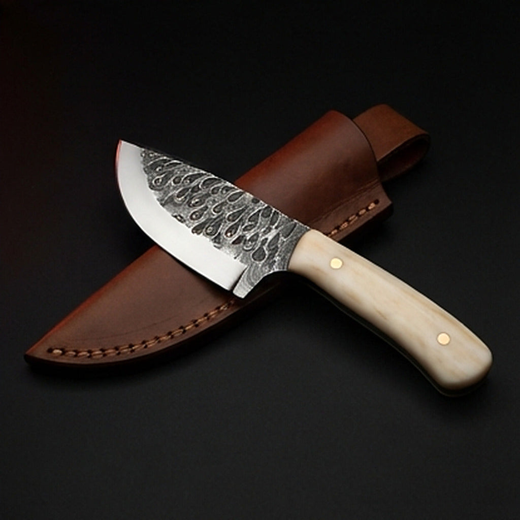 Damascus steel skinning knife with polished camel bone handle and brass pins, with its leather sheath