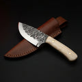 Damascus steel skinning knife with polished camel bone handle and brass pins, with its leather sheath