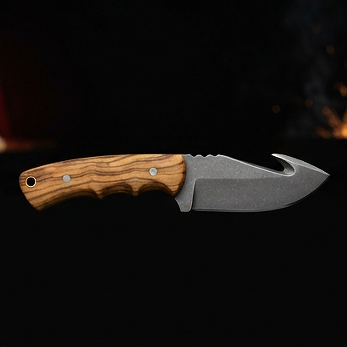 D2 tool steel gut hook skinning knife with olive wood handle and steel pins, right side profile