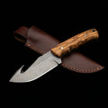 D2 tool steel gut hook skinning knife with olive wood handle and steel pins, with its leather sheath