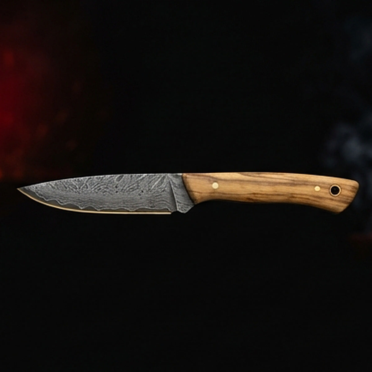 Damascus steel bird and trout knife with slim olive wood handle and brass pin, left side profile