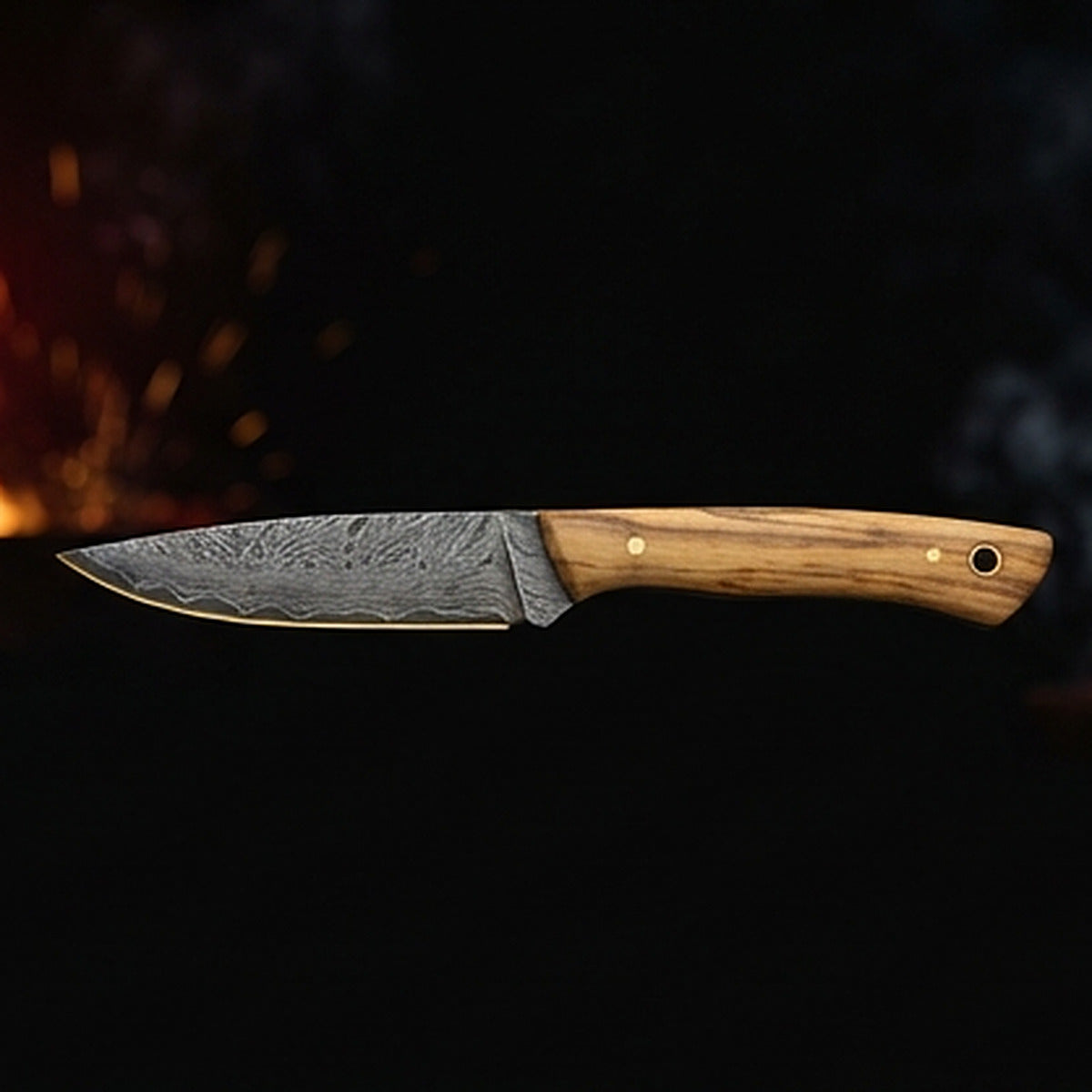 Damascus steel bird and trout knife with slim olive wood handle and brass pin, right side profile