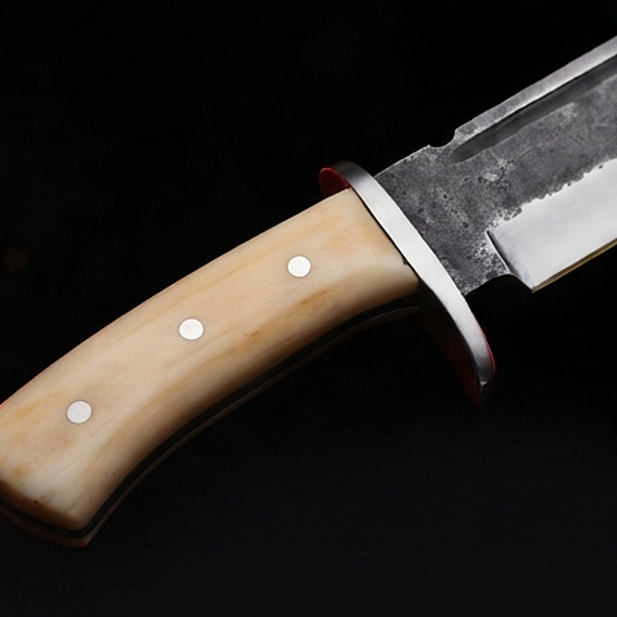 1095 high carbon steel bowie knife with cream bone handle and polished steel guard, handle close up