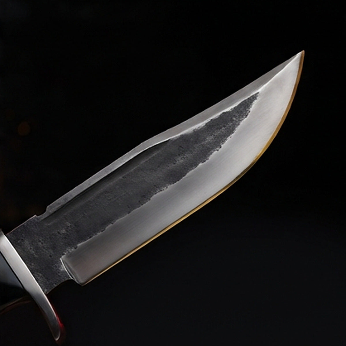 1095 high carbon steel bowie knife with cream bone handle and polished steel guard, cutting edge and tip detail