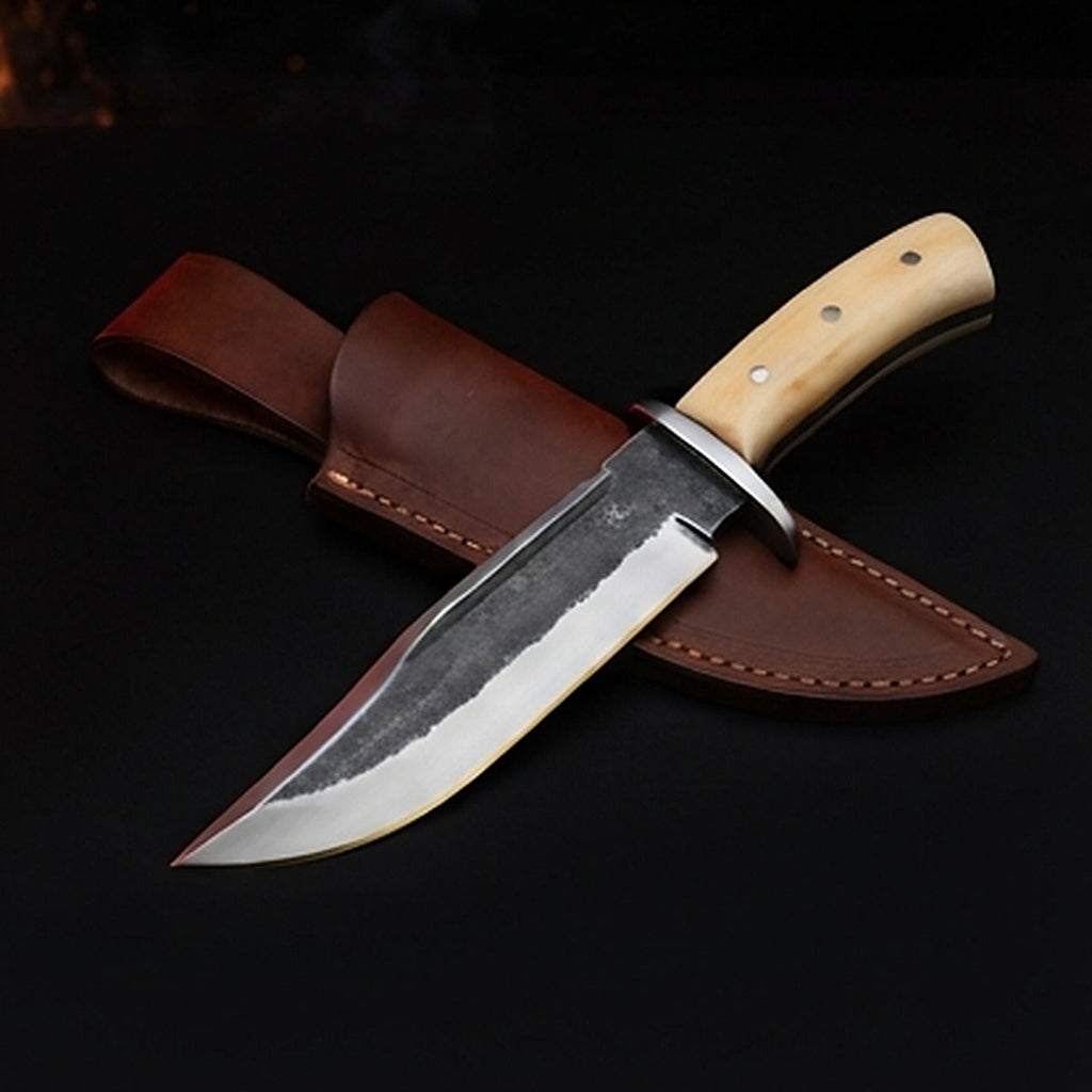 1095 high carbon steel bowie knife with cream bone handle and polished steel guard, with its leather sheath