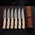 Damascus steak knife set of 6 with camel bone handles in a tooled leather knife roll