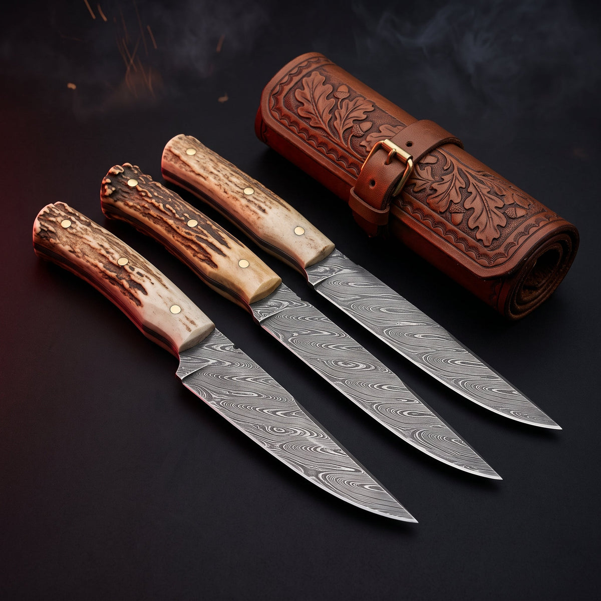 Damascus steak knife set of 4 with stag antler handles in a carved leather knife roll
