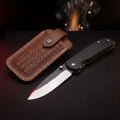 Hand forged liner lock folding knife with black micarta handle and tooled leather pouch