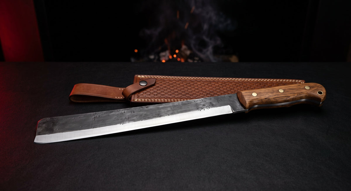 Hand forged machete with an 18 inch straight blade, squared tip, oak handle and a stamped leather sheath