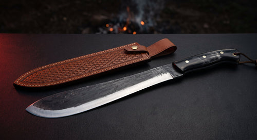 Hand forged bolo machete with a heavy forward belly, water buffalo horn handle and a stamped leather sheath