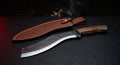 Hand forged kukri machete with a forward dropping blade, broad squared tip, walnut handle and a stamped leather sheath