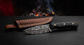 Damascus skinner knife with a ladder pattern blade, wide sweeping belly and a black canvas micarta handle