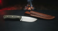 D2 tool steel skinner knife with a plain satin blade, wide sweeping belly and a green canvas micarta handle
