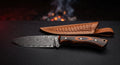 Damascus skinner knife with a raindrop pattern blade and a desert ironwood handle with swirling figure