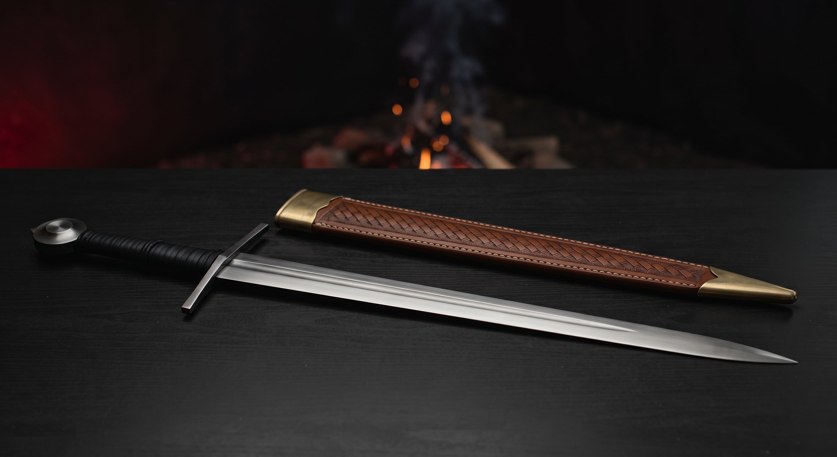 Hand forged medieval arming sword with a tapered fullered blade, flat iron wheel pommel and a stamped leather scabbard