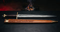 Damascus arming sword with a twist pattern tapered blade, brass Brazil nut pommel and a hand carved leather scabbard